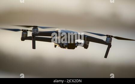 Quadcopter with a camera in flight. Technique for aerial photography ...