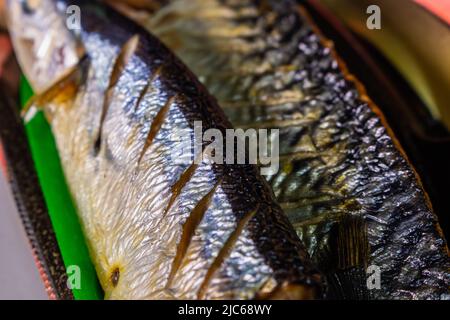 Closeup grilled Japanese Sanma fish (Pacific saury), Shiojake (salted salmon) and Saba No Shioyaki (salted mackerel) in a plastic food tray. Stock Photo