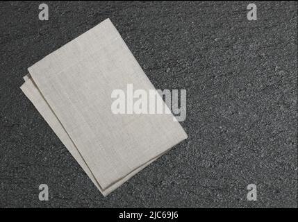 Kitchen cloth on black slate texture background,food decoration backdrop. Stock Photo