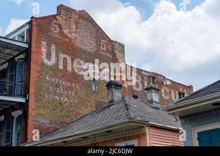 NEW ORLEANS, LA, USA - JUNE 9, 2022: Vintage advertisement for Uneeda Biscuit on side of apartment building in the French Quarter Stock Photo