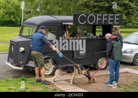 Big dog meets little dog at a coffee van in Gosforth, Newcastle upon Tyne, UK. Stock Photo