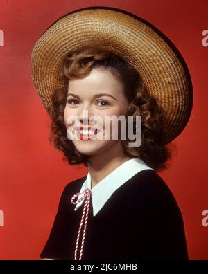 Shirley Temple posing by a painting of young Shirley Temple. 1945 :  r/OldSchoolCool