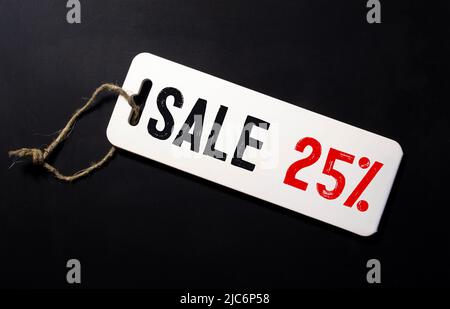 Sale printed with typewriter font on price tag sticker isolated on white background Stock Photo