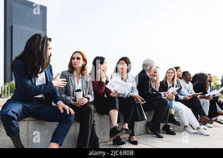 Multiracial business people having a briefing outside the office Stock Photo