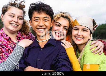 Happy young diverse friends having fun hanging out together - Youth people millennial generation concept Stock Photo