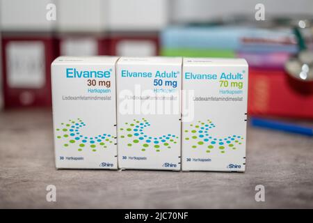 Drug box of  Elvanse containing Lisdexamfetamine for treatment of   attention deficit hyperactivity disorder,on a table and in the background differen Stock Photo