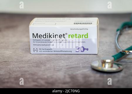 A Drug box of  Medikinet  containing Methylphenidate  for treatment of   attention deficit hyperactivity disorder' (ADHD), on a table and in the backg Stock Photo