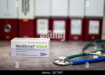 A Drug box of  Medikinet  containing Methylphenidate  for treatment of   attention deficit hyperactivity disorder' (ADHD), on a table and in the backg Stock Photo