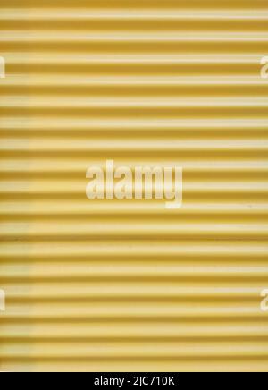 Yellow background and texture of metal corrugated wall Stock Photo
