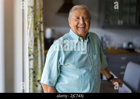 Portrait of a senior man standing in his home Stock Photo
