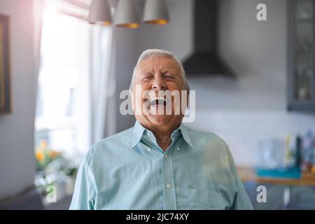 Happy senior man laughing in his home Stock Photo