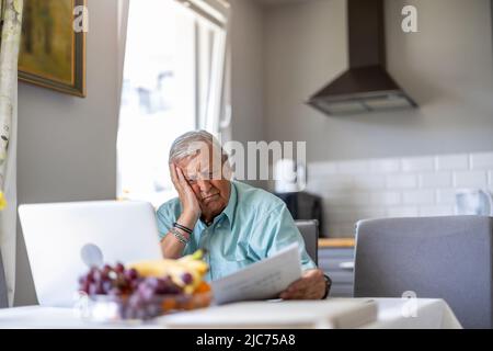 Senior man going through his financials problems Stock Photo