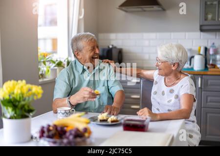 Senior couple having breakfast and talking Stock Photo