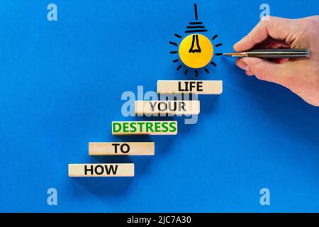 Destress your life symbol. Concept words How to destress your life on wooden blocks. Doctor hand. Beautiful blue background. Psychological business an Stock Photo