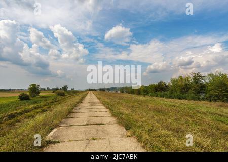 Old concrete way under blue cloudy sky Stock Photo