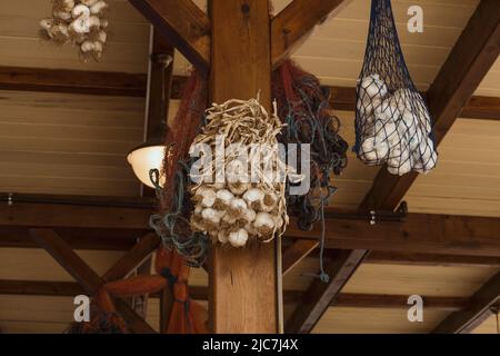 Hanging garlics in a net Stock Photo