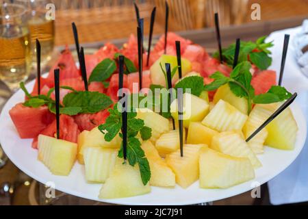 The plate is diced and decorated with melon and watermelon Stock Photo