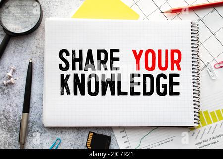 Share Your Knowledge text written on a notebook with pencils. Stock Photo