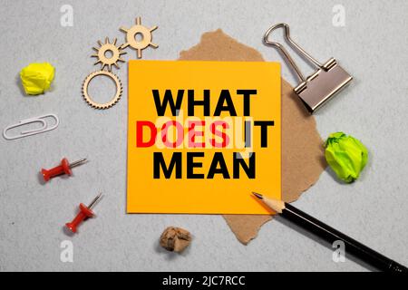 Conceptual hand writing text caption inspiration showing question What Does It Mean. Business concept for question and unknown written on sticky note, Stock Photo