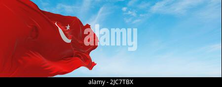 official flag of Islamic State Indonesia at cloudy sky background on sunset, panoramic view. Indonesian travel and patriot concept. copy space for wid Stock Photo