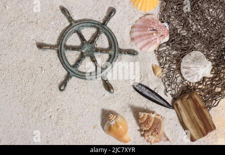 Top view of an empty frame captains wheel with fishing net and sea shells  on wooden background Stock Photo by wirestock