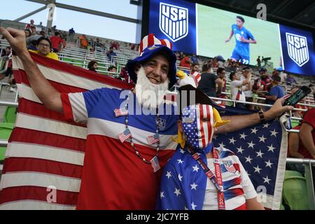 Austin Texas USA, 10th June, 2022: USA fans dressed in stars and stripes garb cheer during first half action of a CONCACAF Nation's League match at Austin's Q2 Stadium. This is the U.S. Men's National Team's (USMNT) final match in the U.S. before the 2022 FIFA World Cup. Credit: Bob Daemmrich/Alamy Live News Stock Photo