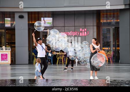 A street vendor selling clear LED balloons outside the Serendipity 3 restaurant in Dubai. Stock Photo
