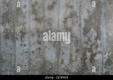 Texture of old reinforced concrete surface. Flat reinforced concrete surface with traces of wooden formwork, covered with dark spots, background. Stock Photo