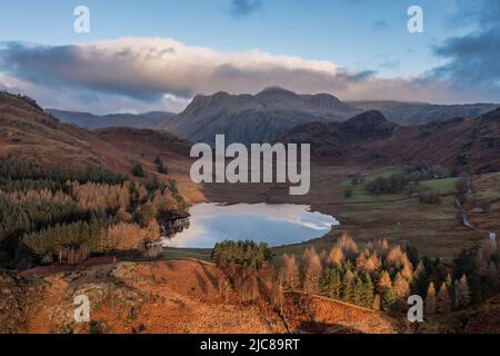 Epic aerial drone landscape image of sunrise from Blea Tarn in Lake District during stunning Autumn showing Stock Photo