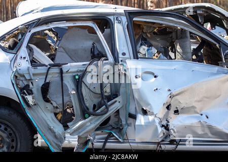 A warped, flattened car after an accident, after a strong side impact. Car accident, insurance concept. Terribly dangerous car after a fatal accident. Stock Photo