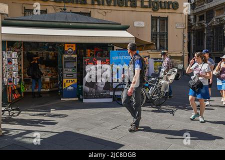 A newsstand in Piazza delle Fontane Marose square with tourists in a sunny spring day, Genoa, Liguria, Italy Stock Photo