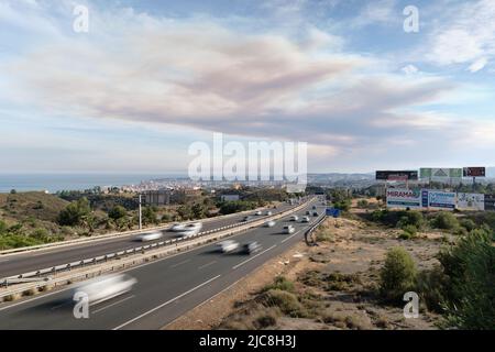 AP-7, autovía del mediterraneo with the smoke cloud of the Pujerra forest fire. Fuengirola, Malaga, Spain. Stock Photo