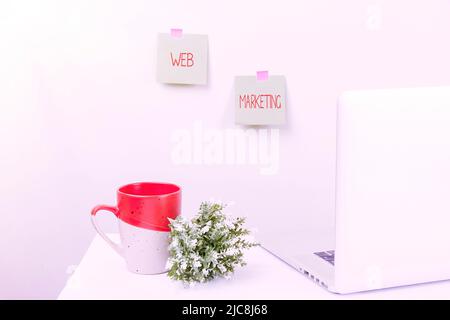 Sign displaying Web Marketing. Internet Concept Electronic commerce Advertising through internet Online seller Tidy Workspace Setup, Writing Desk Stock Photo