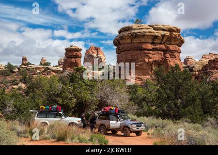 Two 4wd SUV tour vehicles stop for a break in the Maze District of Canyonlands National Park in Utah.  Driving into the Maze requires very experienced Stock Photo