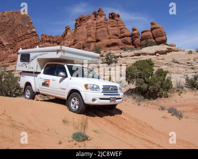 A tour guide maneuvers a 4-wheel drive truck through sandy terrain near Moab, Utah. Stock Photo