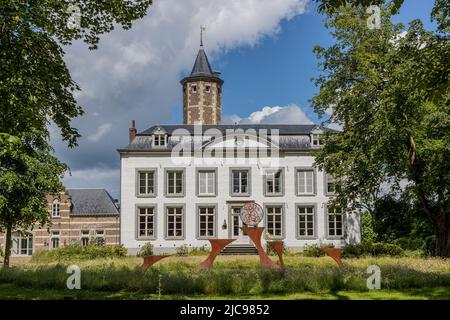 Municipality of Maastricht, South Limburg, Netherlands. June 6, 2022. Facade of the 16th century Jerusalem Castle, trees, white walls, gray roof, wind Stock Photo