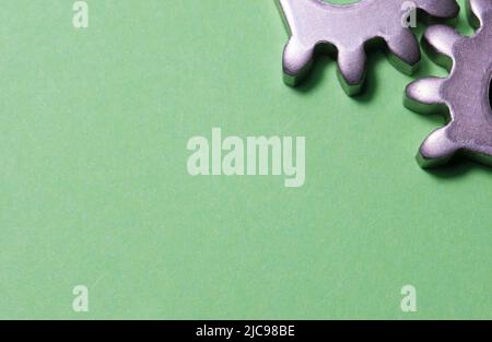 two gears geared on a yellow background with copy space, geared steel sprockets, sprocket, background with gear wheels horizontal Stock Photo