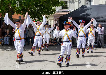 Wimborne, Dorset UK. 11th June 2022. Crowds flock to Wimborne Folk Festival on a warm sunny day to celebrate its 40th birthday with lots of dance groups, music, stalls and other activities around the square and Minster. Credit: Carolyn Jenkins/Alamy Live News Stock Photo