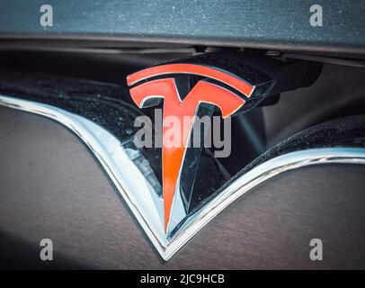 Bucharest, Romania - 05.20.2022: Close up with the logo of the famous american luxury electric car brand Tesla Stock Photo