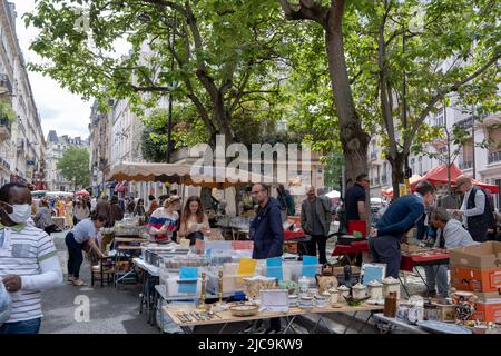 PARIS, FRANCE - JUNE 6, 2022: Tourists and Parisians enjoying a beautiful day on the streets of Paris after pandemic period. Stock Photo