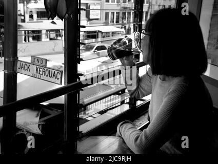 A woman enjoys a pint of beer  at Vesuvio Cafe, a landmark bar in San Francisco, California, frequented by members of the 1950s Beat Generation. Stock Photo