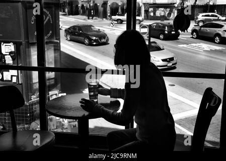 A woman enjoys a pint of beer  at Vesuvio Cafe, a landmark bar in San Francisco, California, frequented by members of the 1950s Beat Generation. Stock Photo