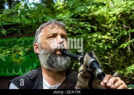 Closeup of bearded bagpiper playing his instrument at Oklahoma Renassiance Festival Muskogee Oklahoma USA 5 13 2018 Stock Photo