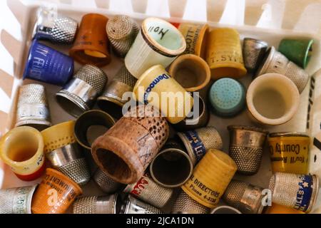 Collection of old and antique thimbles in a basket Tulsa Oklahoma USA 4 18 2018 Stock Photo