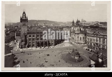 Old Town Hall (Staroměstská radnice) and Saint Nicholas' Church (Kostel svatého Mikuláše) in Old Town Square (Staroměstské náměstí) in Prague, Czechoslovakia, pictured from above, depicted in the Czechoslovak vintage postcard issued around 1940. The neo-Gothic wing of the Old Town Hall which was destroyed in the last days of the World War II is seen in the centre. The monument to Jan Hus designed by Czech sculptor Ladislav Šaloun (1915) is seen in the foreground at the right. Courtesy of the Azoor Postcard Collection. Stock Photo