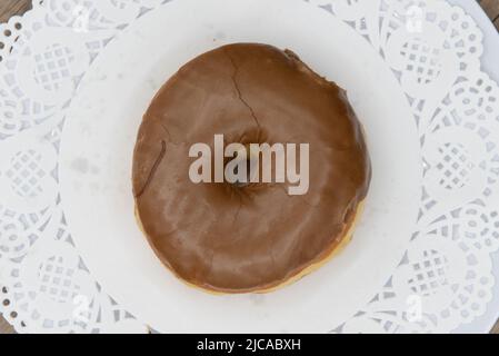 Overhead view of tempting fresh from the oven maple donut from the bakery served on a plate. Stock Photo
