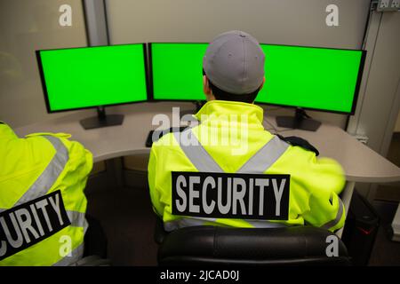 Security team watching over CCTV surveillance monitors. Stock Photo
