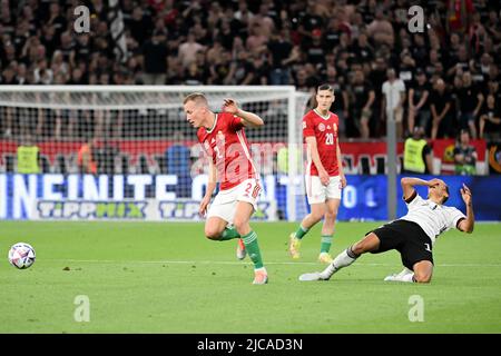 Budapest, Hungary. 11th June, 2022. Soccer: Nations League A, Hungary - Germany, Group stage, Group 3, Matchday 3, Puskás Aréna. Germany's Jamal Musiala (r) and Hungary's Adam Lang in action. Credit: Federico Gambarini/dpa/Alamy Live News Stock Photo