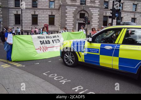 London, England, UK. 11th June, 2022. Protesters block the road in front of a police car in Parliament Square. Extinction Rebellion doctors, nurses and other health professionals gathered for a protest in Westminster to demand an end to fossil fuel investments. (Credit Image: © Vuk Valcic/ZUMA Press Wire)