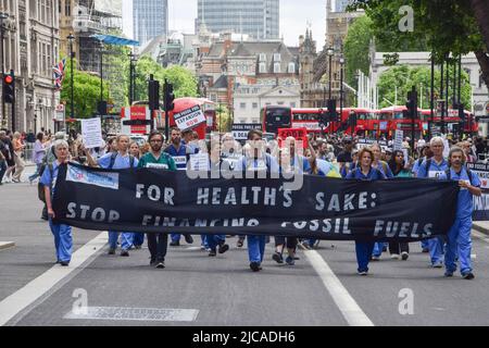 London, England, UK. 11th June, 2022. Protesters march through Whitehall. Extinction Rebellion doctors, nurses and other health professionals gathered for a protest in Westminster to demand an end to fossil fuel investments. (Credit Image: © Vuk Valcic/ZUMA Press Wire) Stock Photo